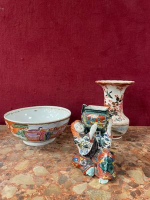 three vases sitting on a table next to a bowl