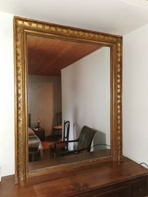 a mirror that is on a dresser in a room