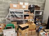 many boxes and other items in a room with a brick wall