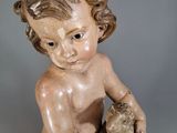 a small statue of a child holding a teddy bear
