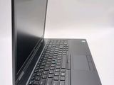 a laptop computer sitting on a table with a keyboard