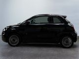 the small black car is parked in a large room