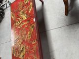 a red box sitting on the floor next to other items
