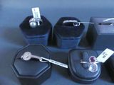 five different rings and a ring box on a table