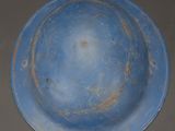 a blue plate with a hole in the middle of it