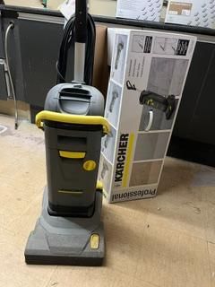 a vacuum that is sitting on the floor next to a box