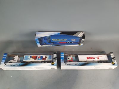 three boxed train cars sitting on top of a table next to each other