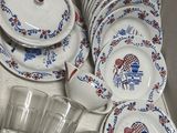 many plates and cups in a box on the counter