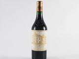 a bottle of wine sitting on top of a white table