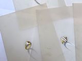 several pieces of paper with rings on them sitting on top of each other