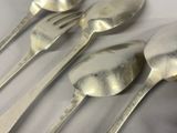 four spoons and two spoons sitting on a table