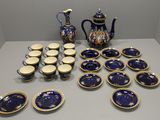 a lot of blue and white plates and a blue and gold teapot