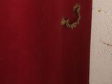 a red chest with gold trim on it in a room