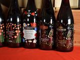 six bottles of wine are lined up on a table