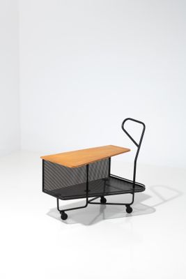 an image of a small black cart with a wooden table on it