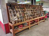 a large display of fishing reels on a wooden stand