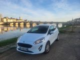 a white car parked on the side of a road next to a river