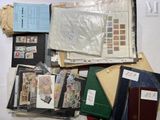 many different types of stamps and envelopes laid out on a table