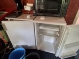 a small kitchen with a microwave on top of it