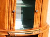 an image of a corner cabinet with a glass door