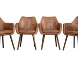 three brown leather chairs sitting next to each other on a white surface