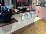 a woman standing at a counter in a restaurant