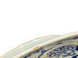 a blue and white plate with a bird on it