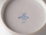 a white bowl with a blue design on it