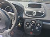 dashboard of a small car with a steering wheel and dashboard controls