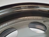 a close up of a tire rim with holes in it