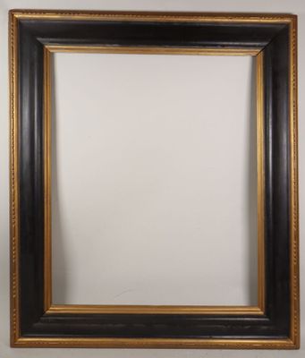 a black and gold picture frame on a white wall