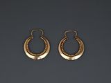 a pair of gold hoop earrings with beaded details