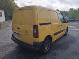 a yellow van that is parked in a parking lot