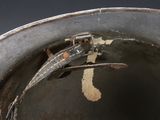 a close up of a metal bucket with a pair of skis sticking out of it