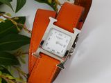 a watch that is sitting on top of a leather band