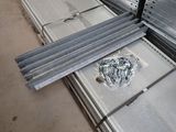 several pieces of metal are stacked on top of each other in a warehouse