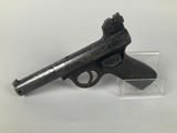 a close up of a gun on display on a white surface