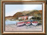 three boats that are sitting on the sand by the water