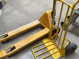 un diable jaune muni d'une fourche dans un entrepôt