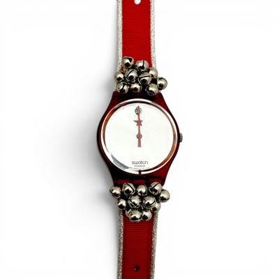 an image of a wrist watch with bells attached to it ' s strap