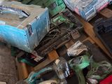 a pile of tools sitting on the floor next to a wall