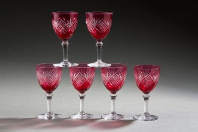 six red wine glasses sitting on top of each other on a table