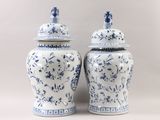 two blue and white vases sitting next to each other