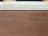 a close up of a wooden box with writing on it