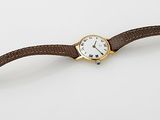 an image of a watch on a white surface with a white background
