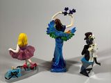 three figurines that are sitting on a table
