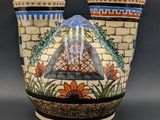 two vases that have been decorated with colorful designs on them