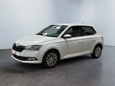 a white car parked in a white room with a black floor