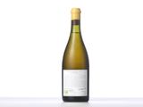 a bottle of white wine sitting on top of a table