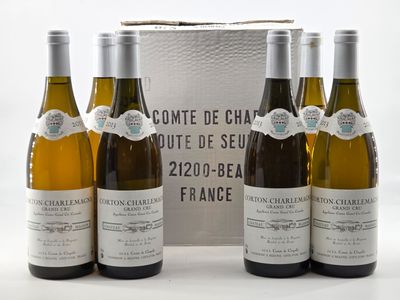 three bottles of white wine sitting next to each other in front of a box